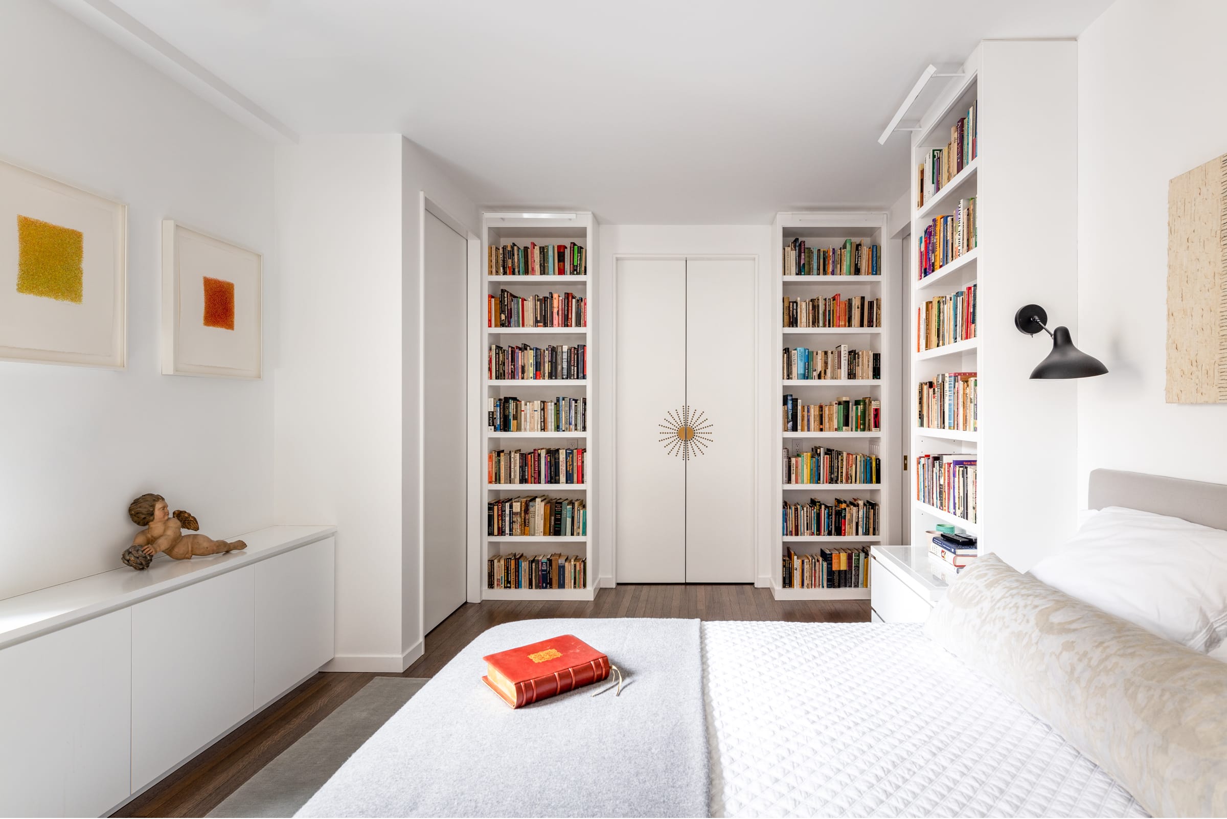 Bedroom with decorative closet doors and bookcases
