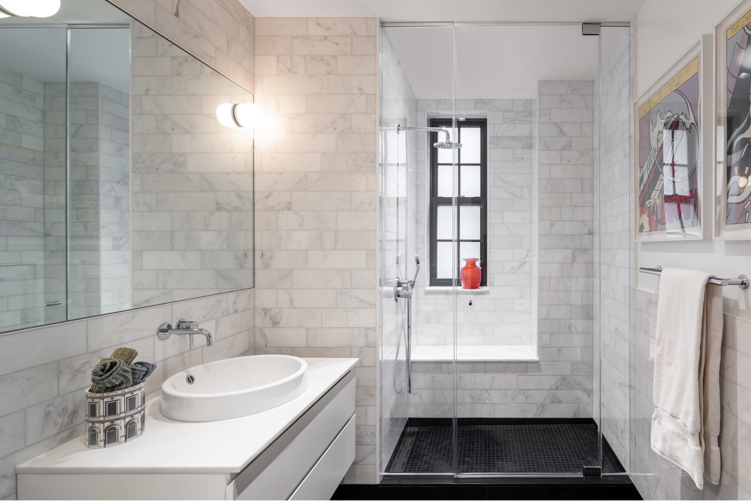 Bathroom with custom shower enclosure and black floor tiles